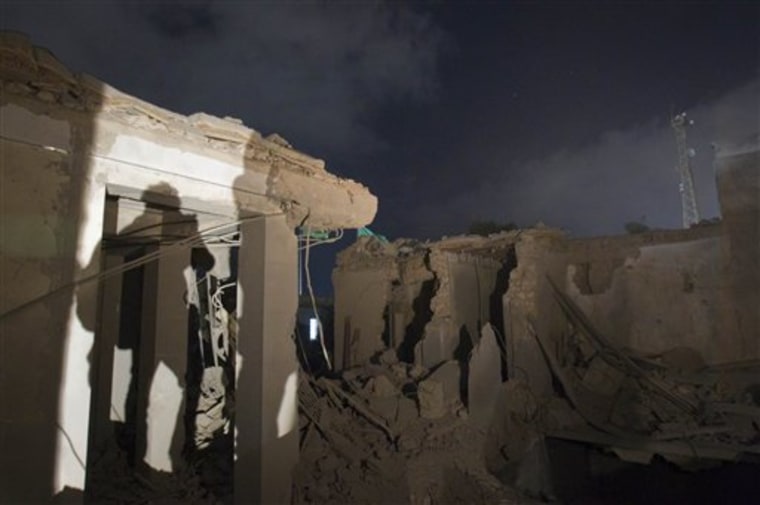 In this photo taken on a government organized tour, the ruins of an official building are seen following an airstrike in Tripoli, Libya, early Tuesday.